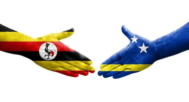 Curacao ve Uganda bayrakları arasındaki tokalaşma ellere boyanmış, izole şeffaf görüntü.