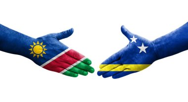 Curacao ve Namibya bayrakları arasındaki el sıkışma ellerinde izole şeffaf görüntü.