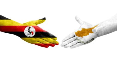 Kıbrıs Rum Kesimi ile Uganda bayrakları arasındaki el sıkışma, izole edilmiş şeffaf görüntü.