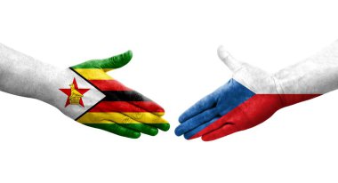 Çek ve Zimbabwe bayrakları arasındaki el sıkışma ellerinde izole şeffaf görüntü.