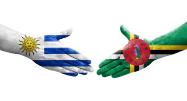 Dominica ve Uruguay bayrakları arasındaki el sıkışma, izole şeffaf görüntü.