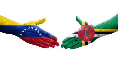 Dominica ve Venezuela bayrakları arasındaki el sıkışma ellerinde resmedilmiş şeffaf görüntü.