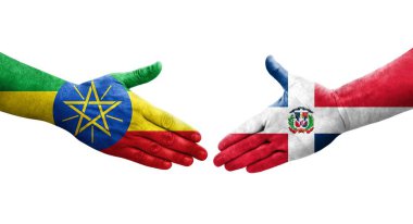 Dominik Cumhuriyeti ile Etiyopya bayrakları arasındaki el sıkışma, izole şeffaf görüntü.