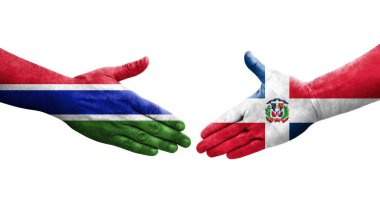 Dominik Cumhuriyeti ve Gambiya bayrakları arasındaki el sıkışma, izole şeffaf görüntü.