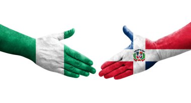 Dominik Cumhuriyeti ve Nijerya bayrakları arasındaki tokalaşma elleri boyalı, izole şeffaf görüntü.