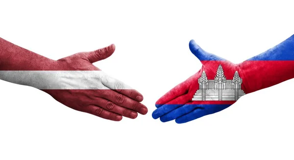 stock image Handshake between Cambodia and Latvia flags painted on hands, isolated transparent image.