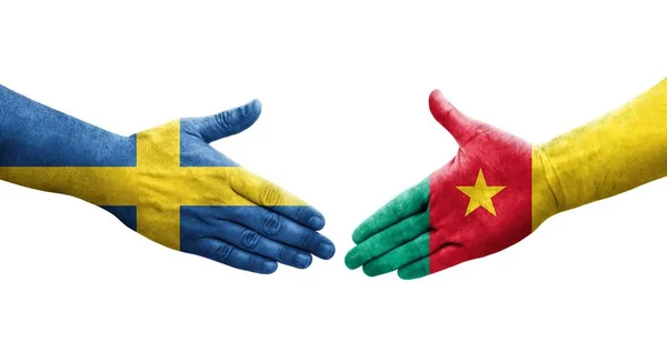 stock image Handshake between Cameroon and Sweden flags painted on hands, isolated transparent image.