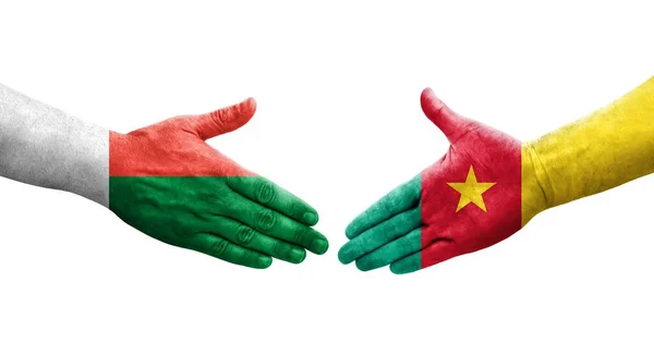 stock image Handshake between Cameroon and Madagascar flags painted on hands, isolated transparent image.