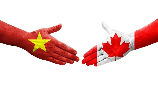 stock image Handshake between Canada and Vietnam flags painted on hands, isolated transparent image.