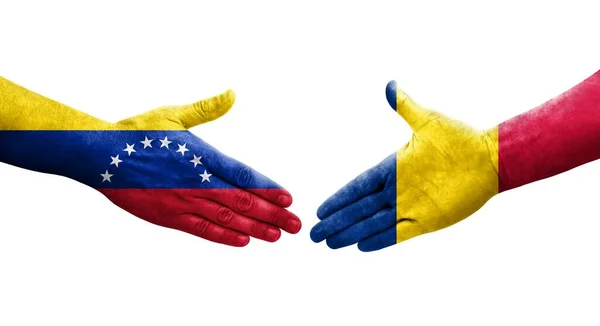 stock image Handshake between Chad and Venezuela flags painted on hands, isolated transparent image.