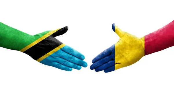 stock image Handshake between Chad and Tanzania flags painted on hands, isolated transparent image.