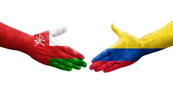 Χειραψία Μεταξύ Κολομβίας Και Ομάν Σημαίες Ζωγραφισμένα Στα Χέρια Απομονωμένη — Φωτογραφία Αρχείου