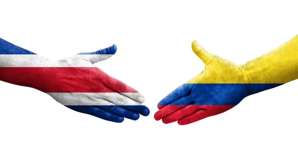 stock image Handshake between Colombia and Costa Rica flags painted on hands, isolated transparent image.