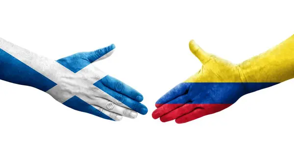 stock image Handshake between Colombia and Scotland flags painted on hands, isolated transparent image.