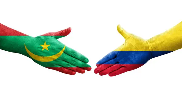 stock image Handshake between Colombia and Mauritania flags painted on hands, isolated transparent image.