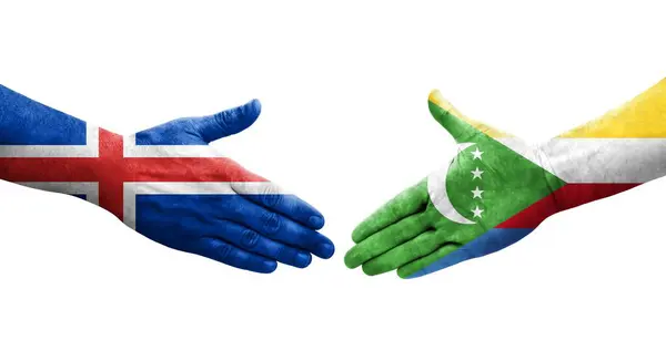 stock image Handshake between Comoros and Iceland flags painted on hands, isolated transparent image.