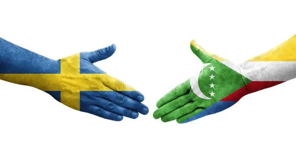 stock image Handshake between Comoros and Sweden flags painted on hands, isolated transparent image.