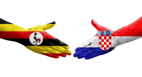Handslag Mellan Kroatien Och Uganda Flaggor Målade Händer Isolerad Transparent — Stockfoto