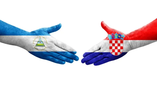 Рукостискання Між Хорватією Нікарагуа Прапори Намальовані Руках Ізольований Прозорий Образ — стокове фото