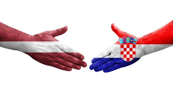 Apretón Manos Entre Croacia Letonia Banderas Pintadas Las Manos Imagen — Foto de Stock
