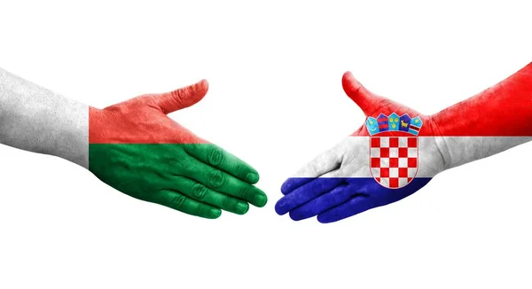 Handslag Mellan Kroatien Och Madagaskar Flaggor Målade Händer Isolerad Transparent — Stockfoto