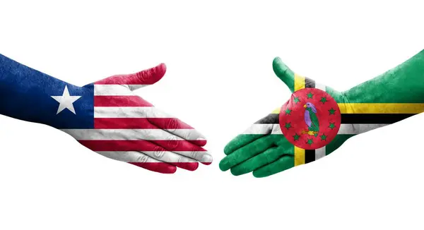 Händedruck Zwischen Dominica Und Liberia Flaggen Auf Hände Gemalt Isoliertes — Stockfoto