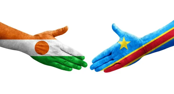 stock image Handshake between Dr Congo and Niger flags painted on hands, isolated transparent image.