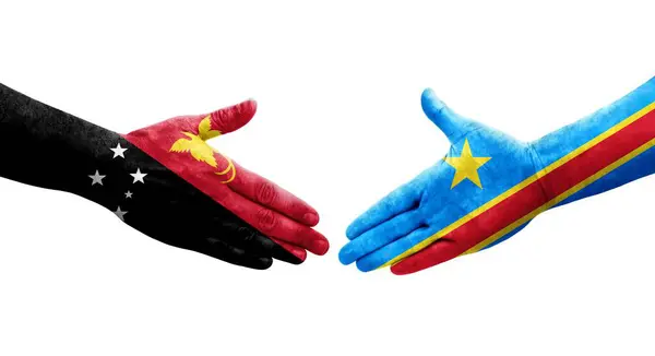 stock image Handshake between Dr Congo and Papua New Guinea flags painted on hands, isolated transparent image.