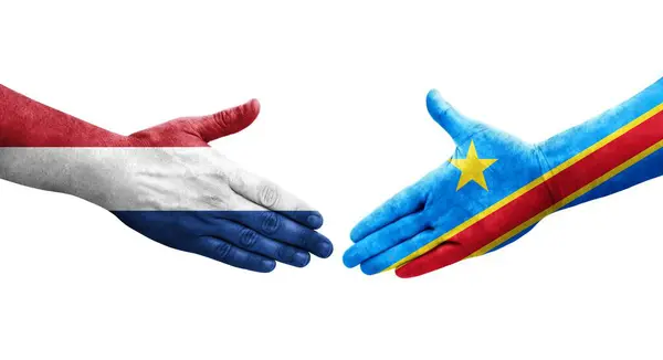 stock image Handshake between Dr Congo and Netherlands flags painted on hands, isolated transparent image.