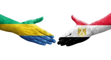 Mısır ve Gabon bayrakları arasındaki el sıkışma ellere boyanmış, izole şeffaf görüntü.