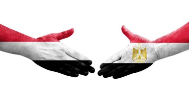Mısır ve Yemen bayrakları arasındaki el sıkışma ellerinde resmedilmiş şeffaf bir görüntü.