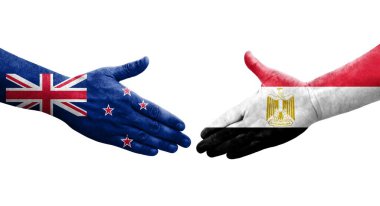 Mısır ve Yeni Zelanda bayrakları arasında el sıkışma, izole şeffaf görüntü.