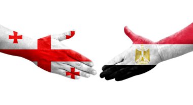 Mısır ve Gürcistan bayrakları arasındaki el sıkışma ellerinde resmedilmiş şeffaf bir görüntü.