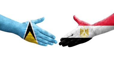 Mısır ve Aziz Lucia bayrakları arasındaki el sıkışma ellerinde resmedilmiş şeffaf bir görüntü.