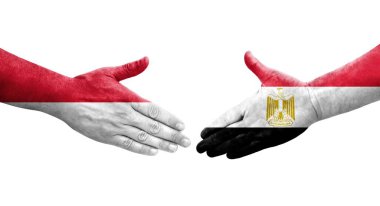 Mısır ve Monako bayrakları arasındaki el sıkışma ellerinde resmedilmiş şeffaf görüntü.