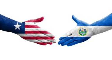 El Salvador ve Liberya bayrakları arasındaki tokalaşma elleri boyalı, izole şeffaf görüntü.