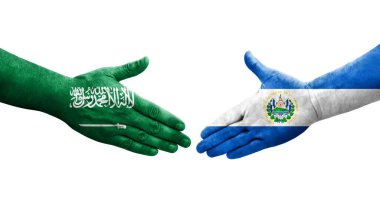 El Salvador ve Suudi Arabistan bayrakları arasındaki el sıkışma, izole şeffaf görüntü.