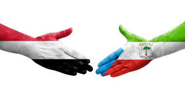 Ellere boyanmış Ekvator Ginesi ve Yemen bayrakları arasındaki el sıkışma, izole şeffaf görüntü.