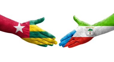 Ellere boyanmış Ekvator Ginesi ve Togo bayrakları arasındaki el sıkışma, izole şeffaf görüntü.