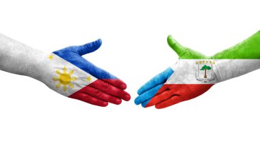 Ekvator Ginesi ve Filipinler arasındaki el sıkışma ellerinde boyanmış bayraklar, izole şeffaf görüntü.