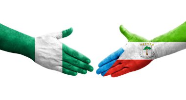 Ekvator Ginesi ve Nijerya bayrakları arasındaki el sıkışma ellerinde resmedilmiş şeffaf görüntü.