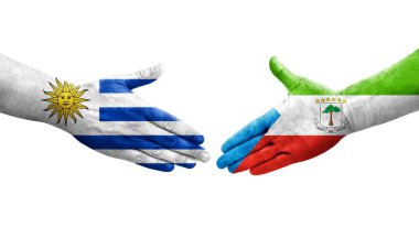 Ekvator Ginesi ve Uruguay bayrakları arasındaki el sıkışma, izole şeffaf görüntü.