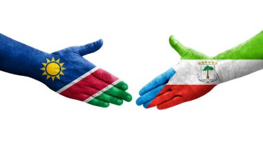 Ellere boyanmış Ekvator Ginesi ve Namibya bayrakları arasındaki el sıkışma, izole şeffaf görüntü.