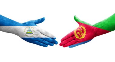 Eritre ve Nikaragua bayrakları arasındaki el sıkışma ellerinde izole şeffaf görüntü.