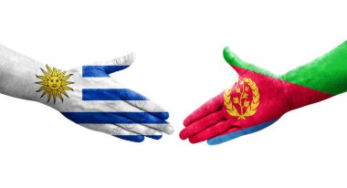 Eritre ve Uruguay bayrakları arasındaki el sıkışma ellerinde izole şeffaf görüntü.