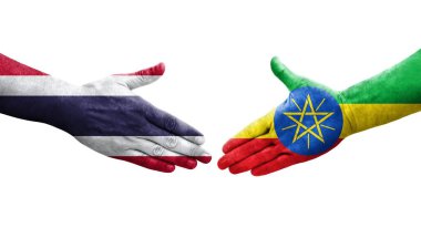 Etiyopya ve Tayland bayrakları arasındaki el sıkışma ellerinde izole şeffaf görüntü.