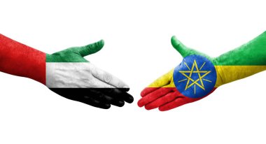 Etiyopya ve BAE bayrakları arasındaki el sıkışma ellerinde izole şeffaf görüntü.