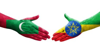 Etiyopya ve Maldivler arasındaki el sıkışma ellerinde boyanmış bayraklar, izole şeffaf görüntü.