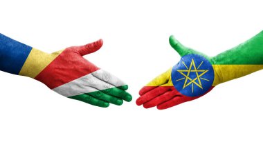 Etiyopya ve Seyşeller arasındaki el sıkışma ellerinde boyanmış bayraklar, izole şeffaf görüntü.