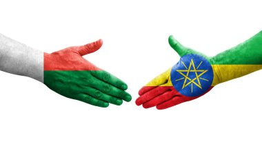 Etiyopya ve Madagaskar bayrakları arasındaki el sıkışma ellerinde izole şeffaf görüntü.